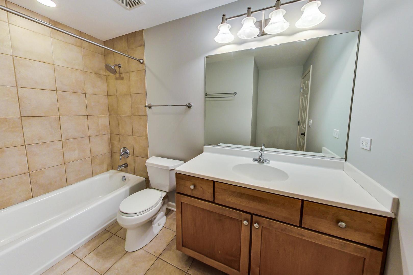 4017 North Troy Street, Unit 2W Chicago, IL 60618 - Photo 14 of 18 a bathroom with a sink a toilet and shower