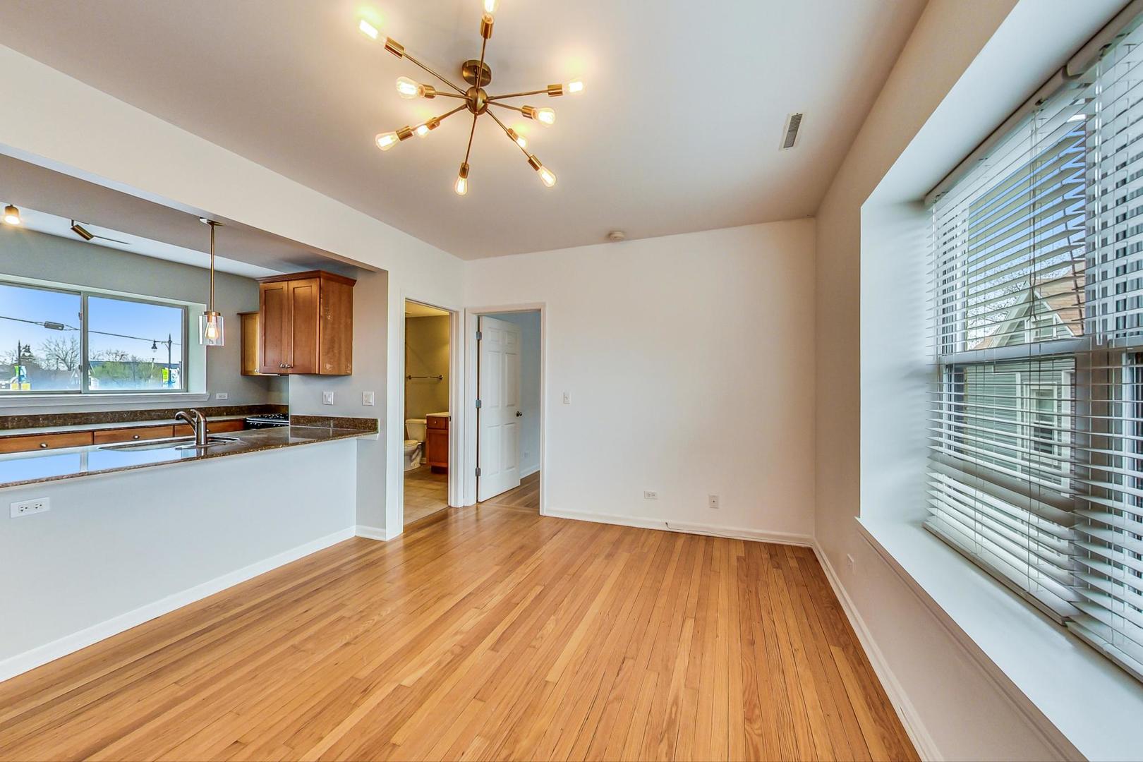 4017 North Troy Street, Unit 2W Chicago, IL 60618 - Photo 4 of 18 a view of a big room with wooden floor and staircase