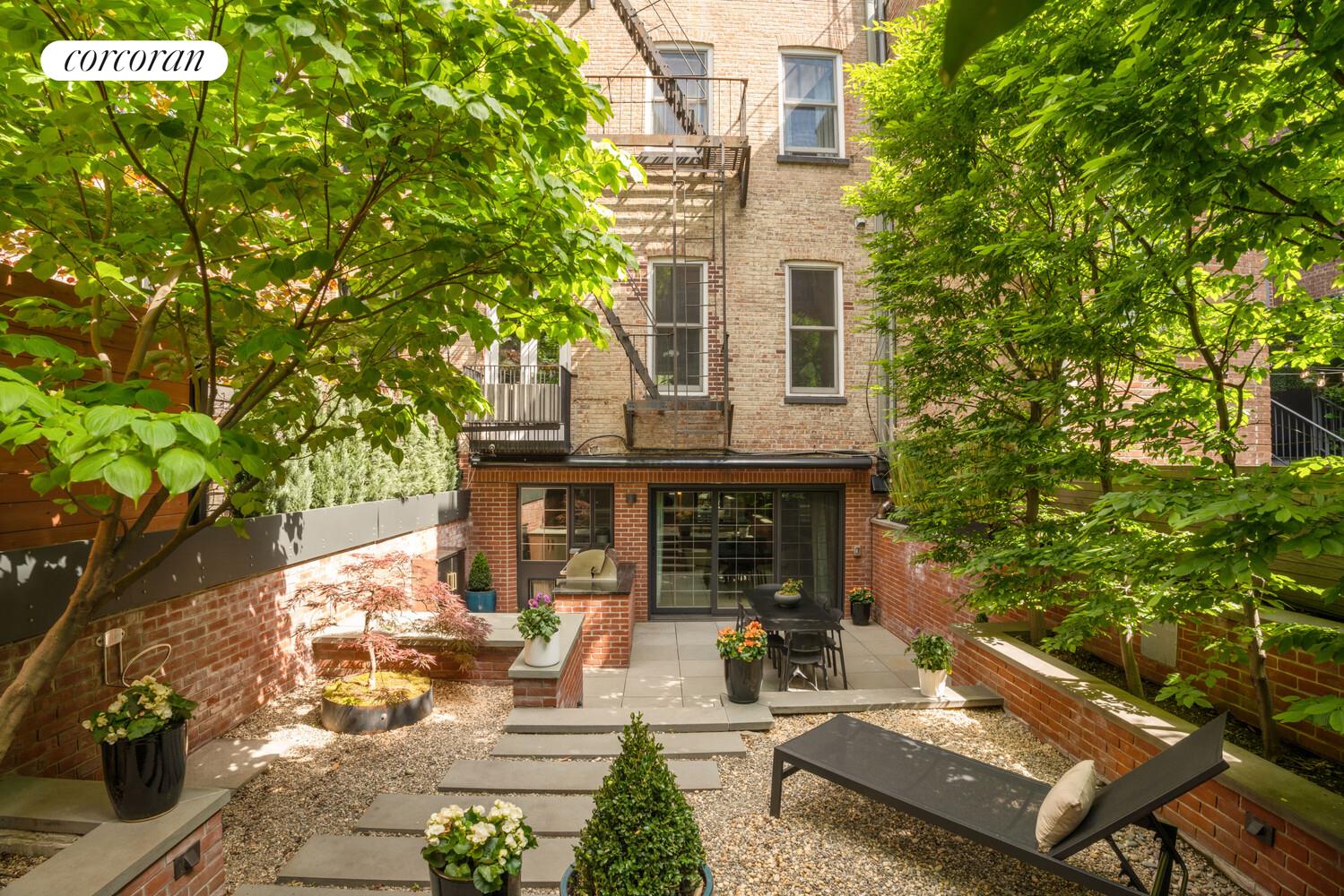 21 Bethune Street, Unit GARDEN Manhattan, NY 10014 - Photo 6 of 8 a view of a patio with table and chairs and potted plants