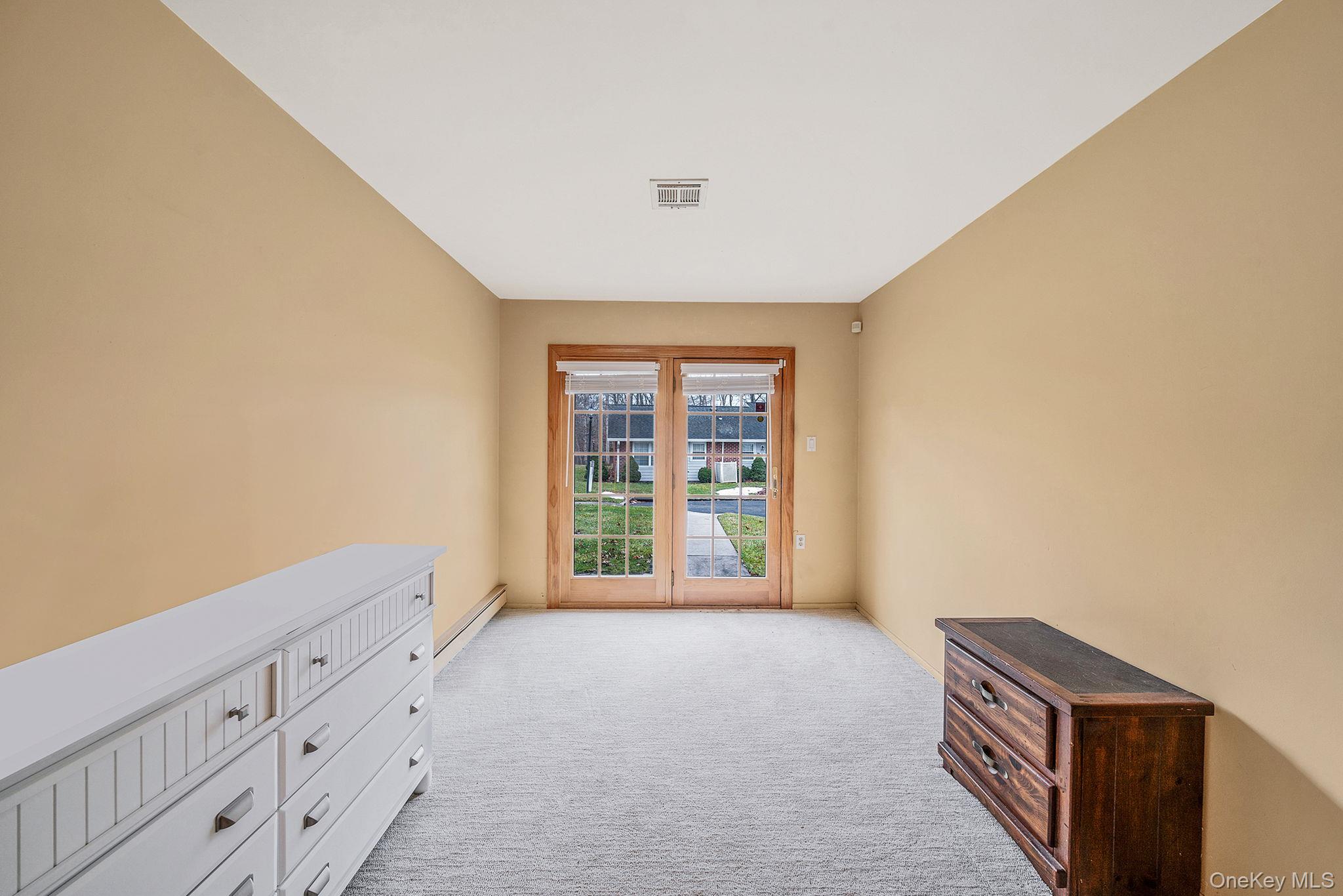 116 B Exmore Court Ridge, NY 11961 - Photo 14 of 19 a view of an empty room and window