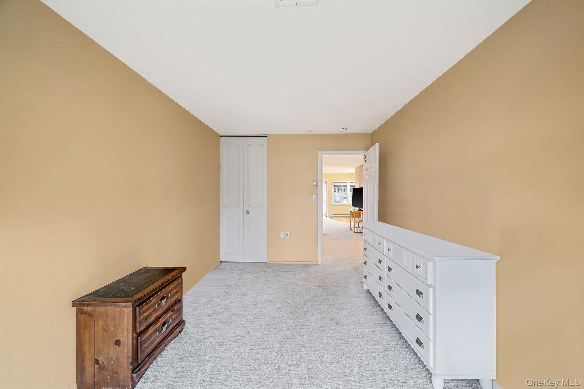 116 B Exmore Court Ridge, NY 11961 - Photo 15 of 19 a view of an empty room and wooden floor