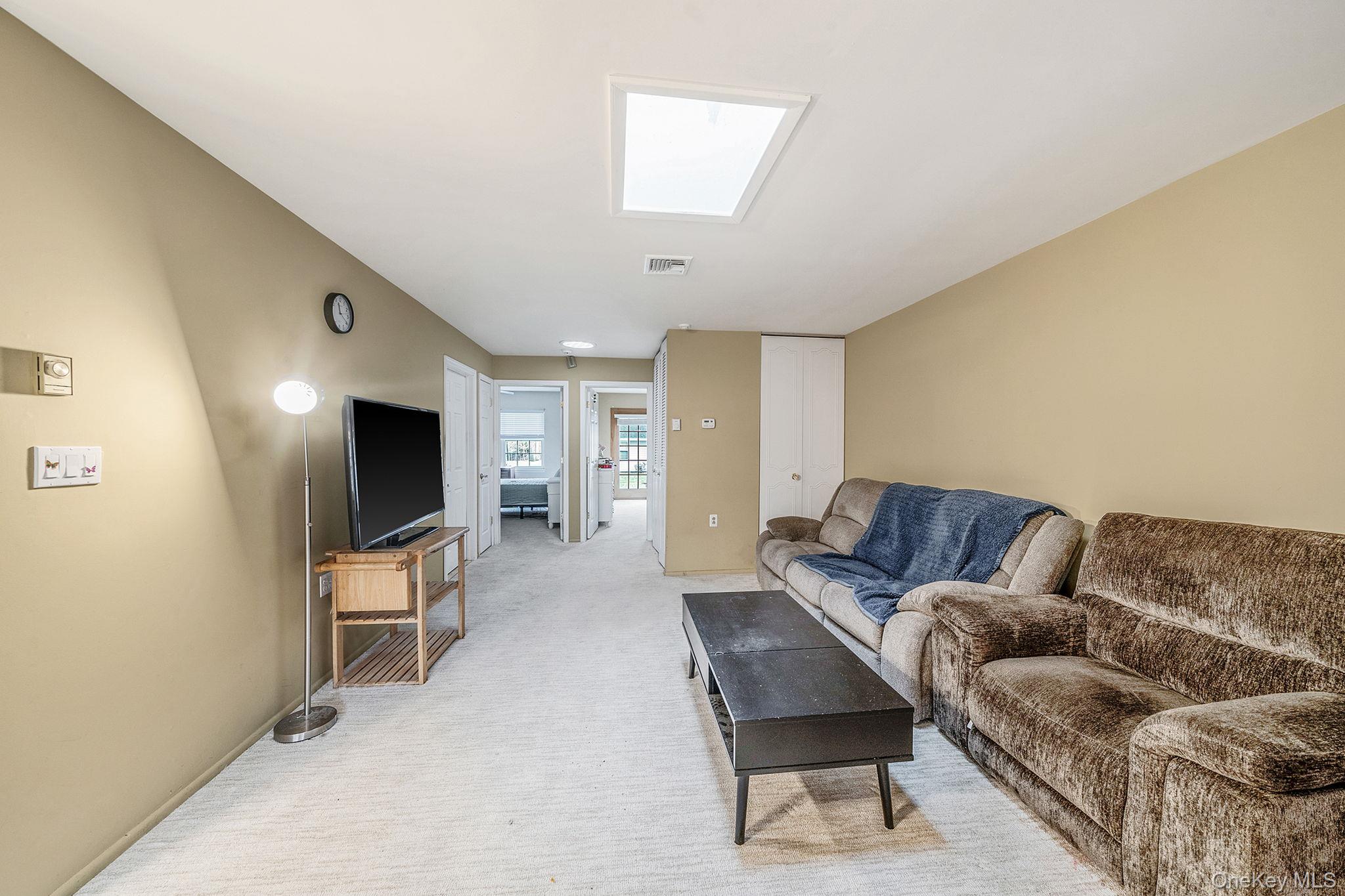 116 B Exmore Court Ridge, NY 11961 - Photo 7 of 19 a living room with furniture and a flat screen tv