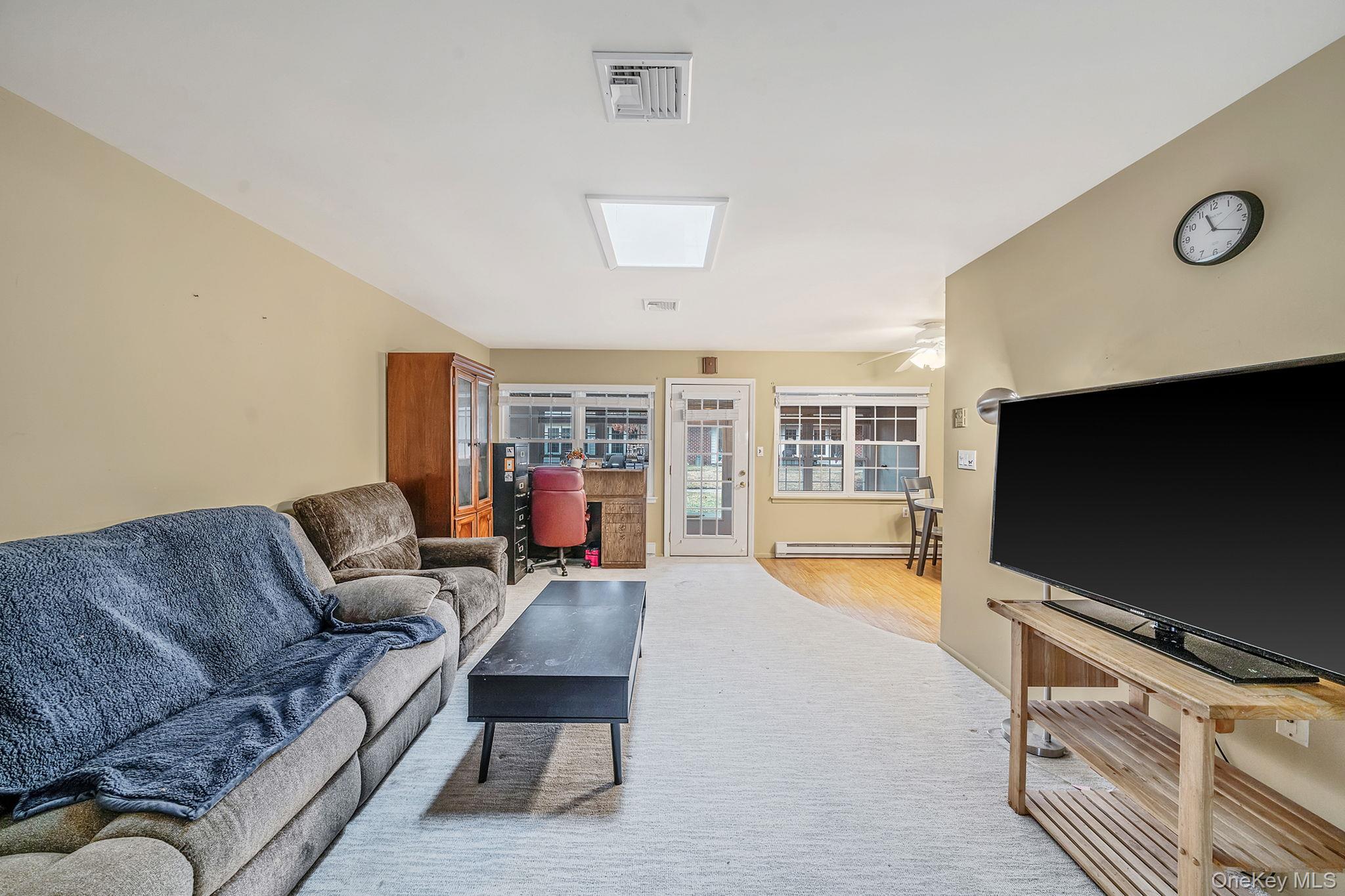 116 B Exmore Court Ridge, NY 11961 - Photo 8 of 19 a living room with furniture and a flat screen tv