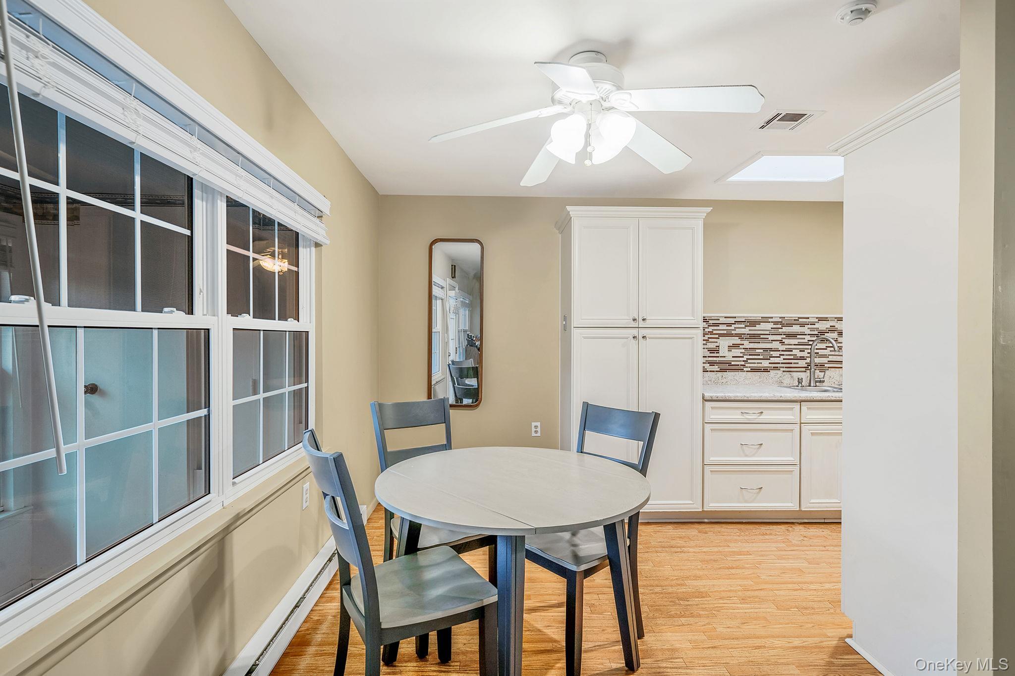 116 B Exmore Court Ridge, NY 11961 - Photo 9 of 19 a view of a dining room with furniture window and wooden floor