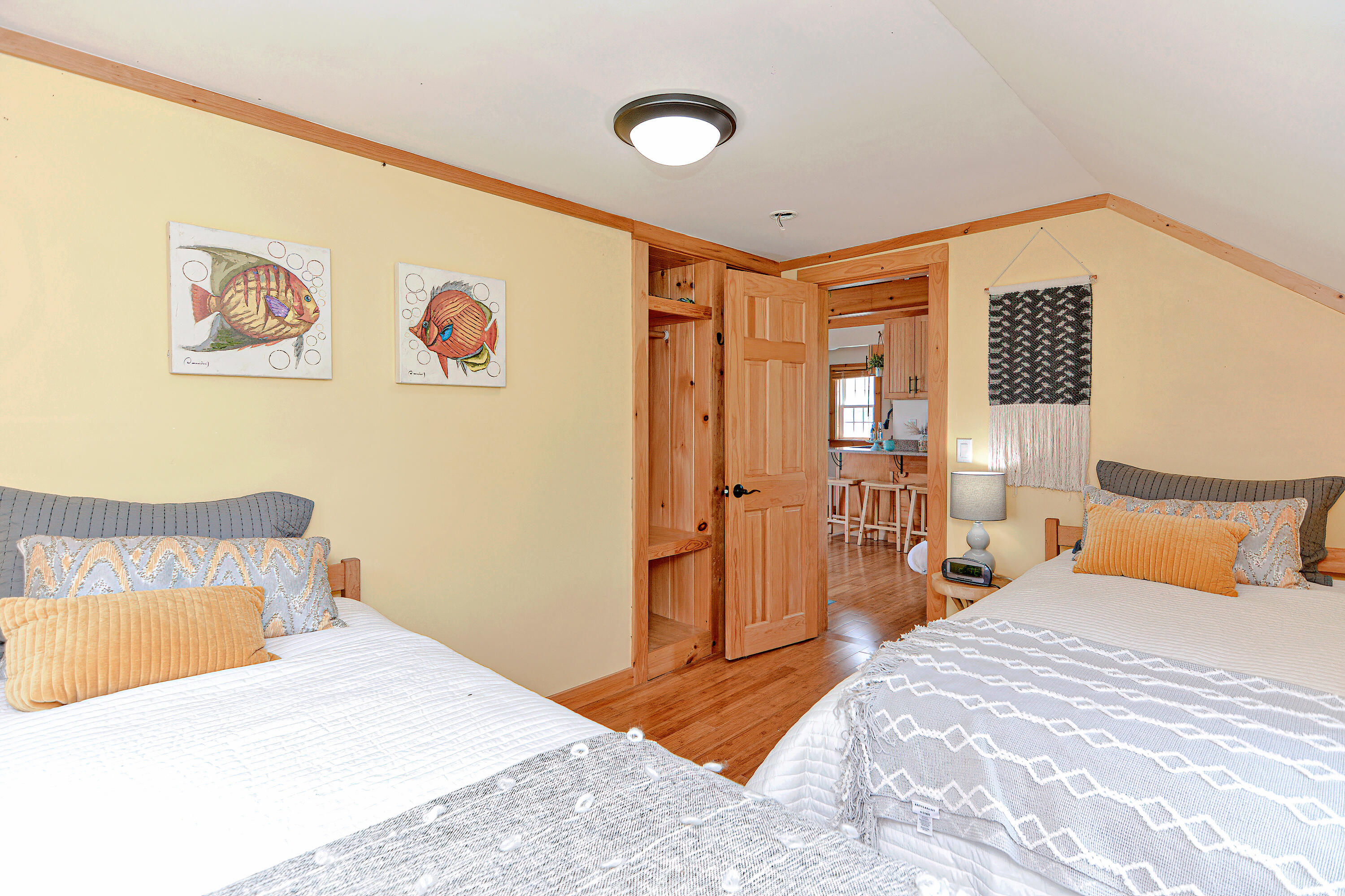 279 Harbor Point Road, Unit 12 Cummaquid, MA 02675 - Photo 12 of 35 a bedroom with a bed and a painting on the wall