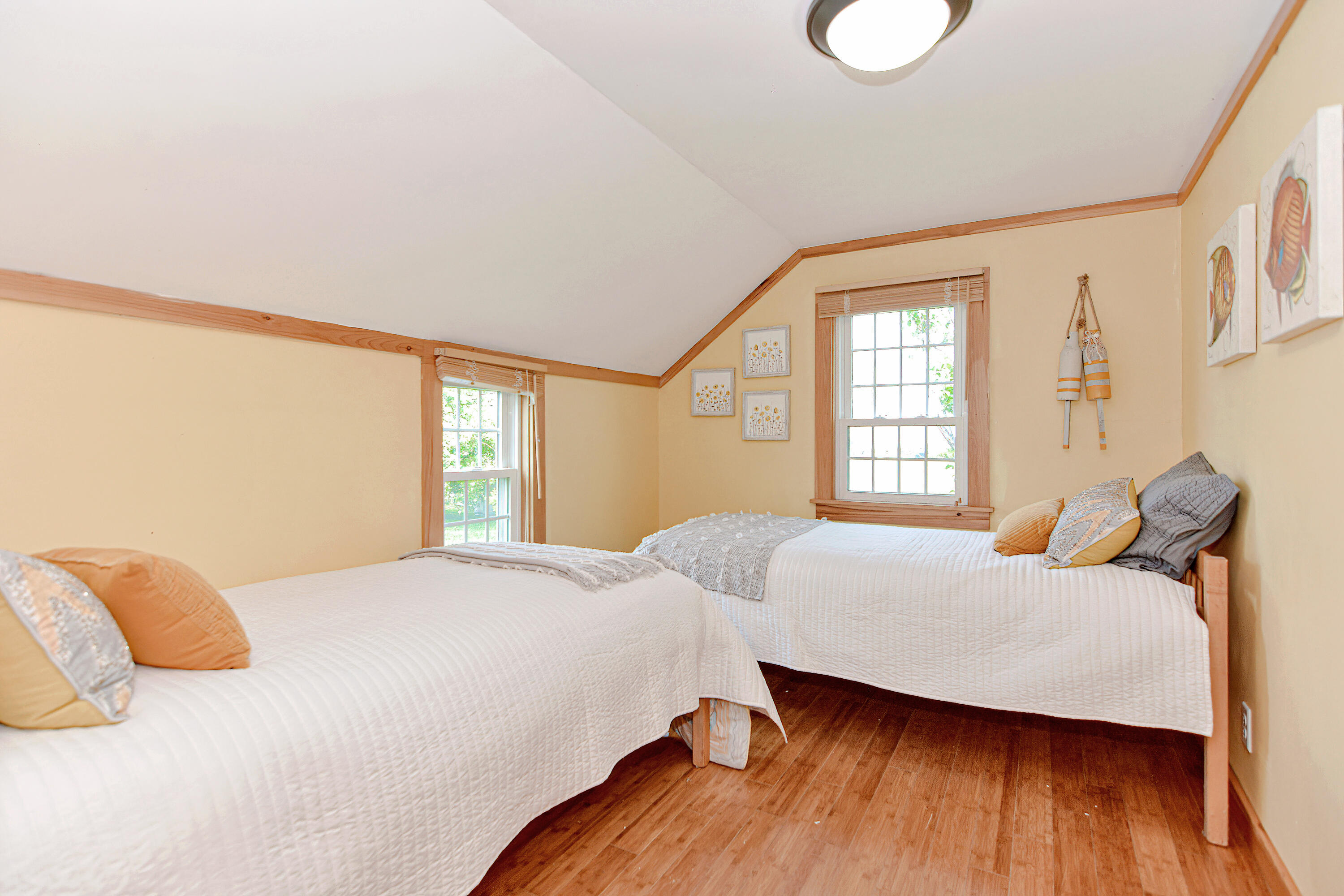 279 Harbor Point Road, Unit 12 Cummaquid, MA 02675 - Photo 13 of 35 a bedroom with a bed and wooden floor