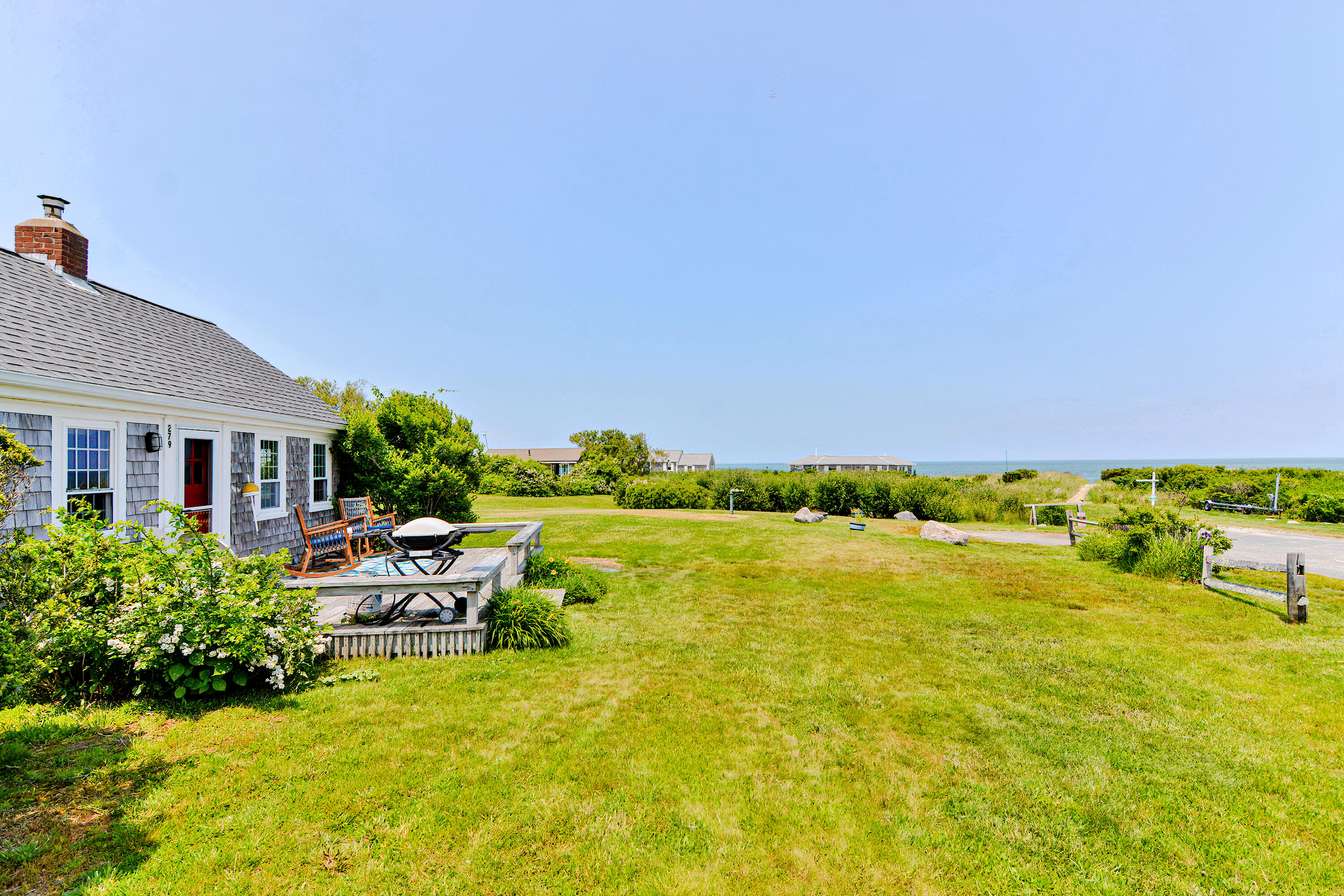 279 Harbor Point Road, Unit 12 Cummaquid, MA 02675 - Photo 20 of 35 a view of a swimming pool and lounge chairs
