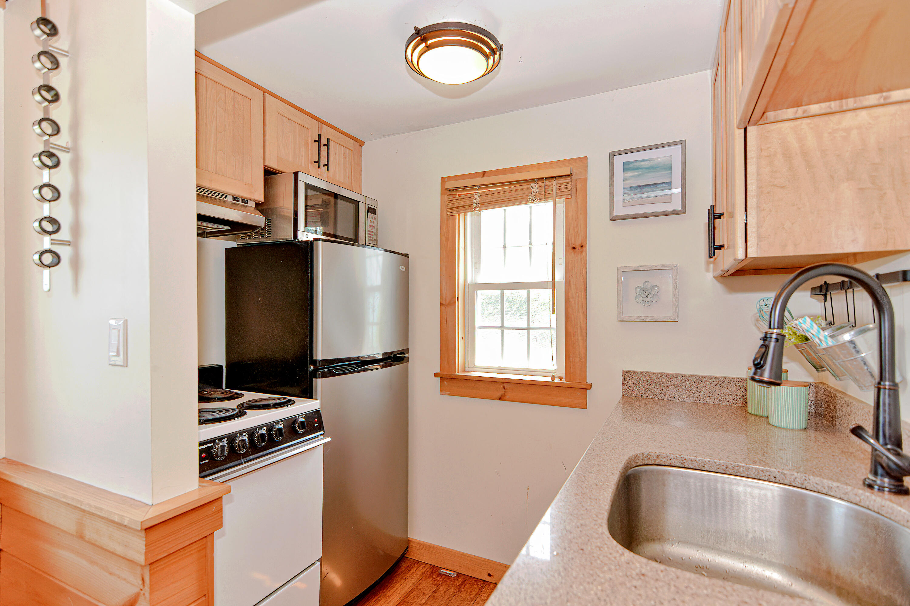 279 Harbor Point Road, Unit 12 Cummaquid, MA 02675 - Photo 9 of 35 a kitchen with stainless steel appliances granite countertop a sink stove and refrigerator