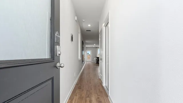 a kitchen with stainless steel appliances a dining table and chairs