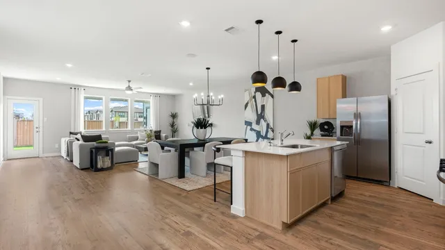 a kitchen with cabinets table and chairs