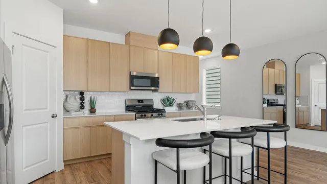 a living room with lots of furniture and kitchen view
