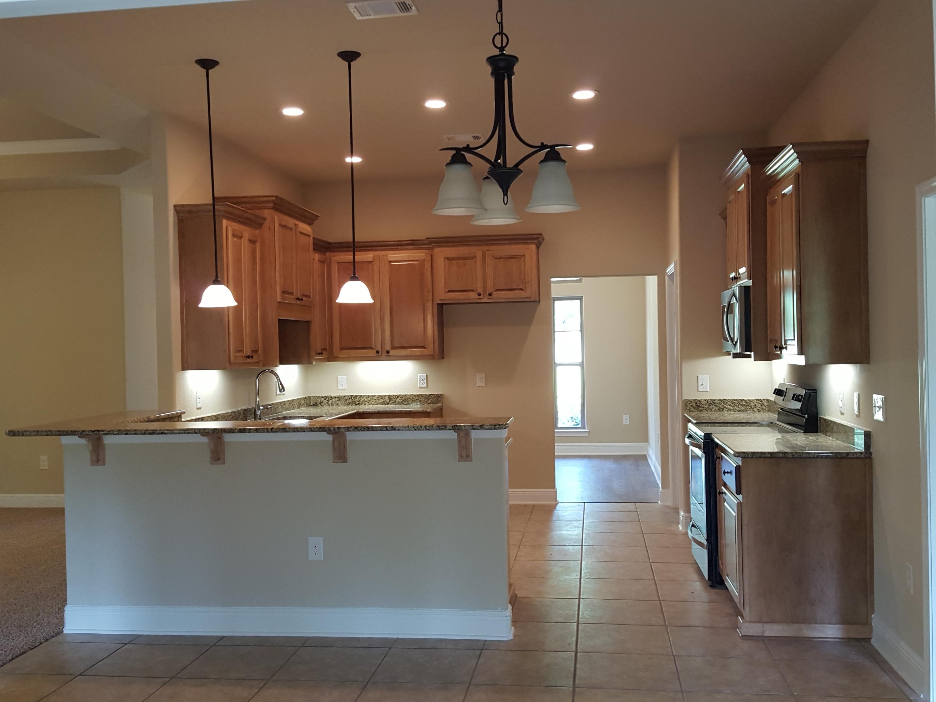 515 Vale Loop Crestview, FL 32536 - Photo 8 of 28 a large kitchen with stainless steel appliances kitchen island a large counter top