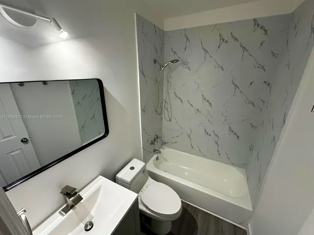 a bathroom with a sink a toilet and a bathtub