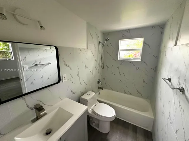 a bathroom with a toilet sink and bathtub