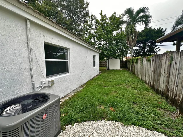 a backyard of a house with table and chairs