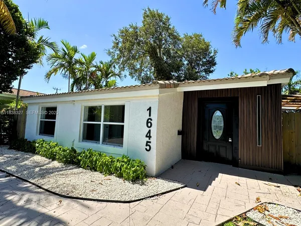 a view of house with yard and swimming pool
