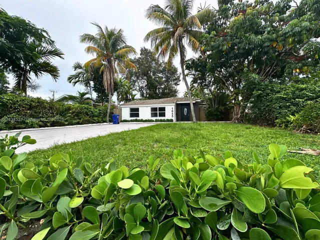 a view of house with yard and swimming pool