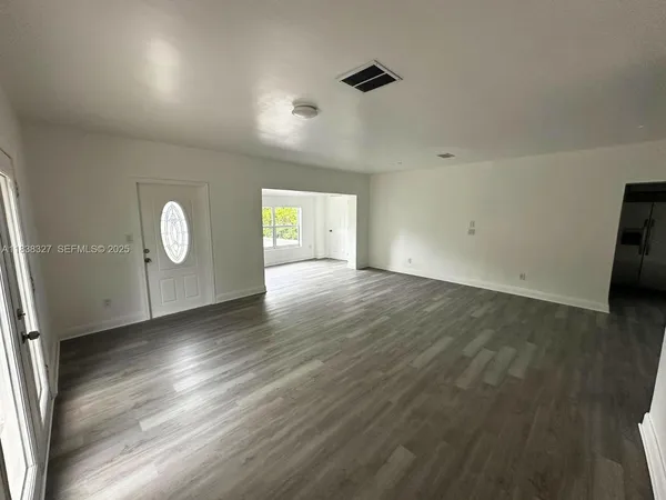 a view of wooden floor and windows in a room