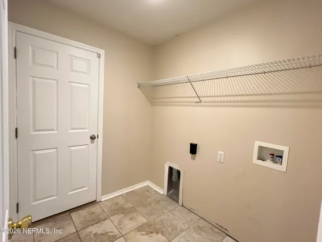 an empty room with a ceiling fan and a window