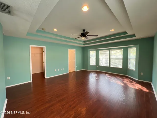a bathroom with a sink a toilet a mirror and shower