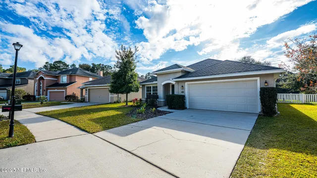 a large kitchen with stainless steel appliances lots of counter space and wooden floor