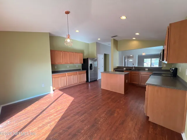 a kitchen with a refrigerator and cabinets