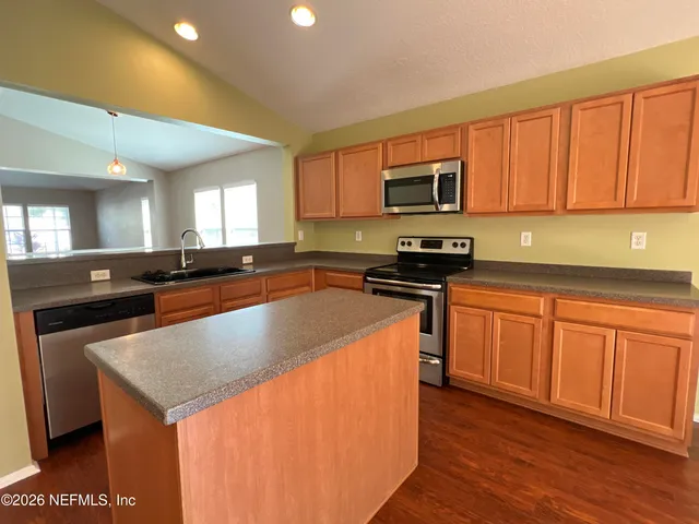 a bathroom with a double vanity sink toilet and shower