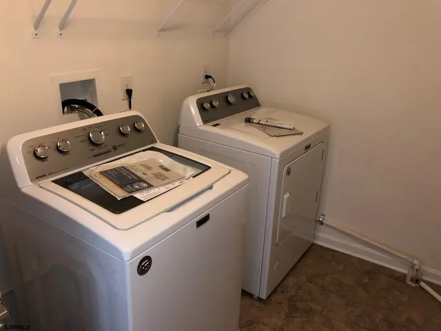 a view of a storage and utility room with a washer dryer