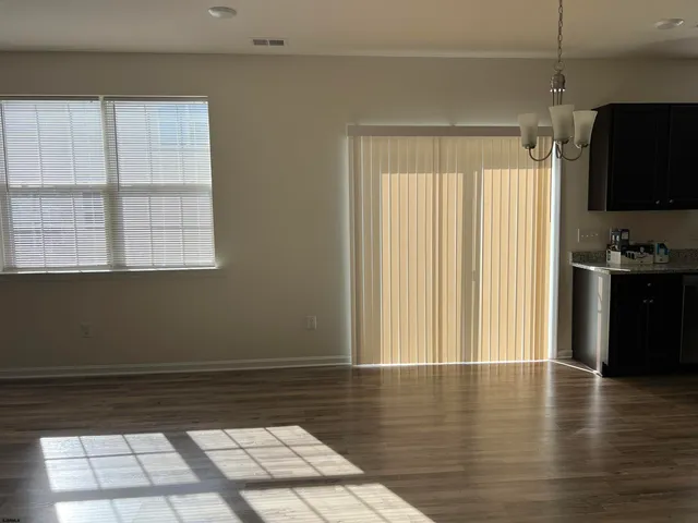 a view of a room with wooden floor and a window