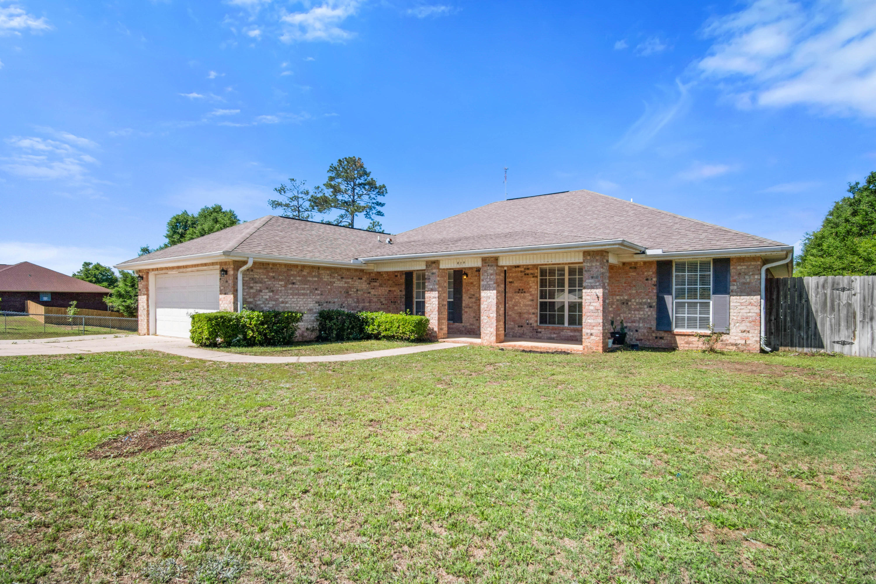 427 Triton Street Crestview, FL 32536 - Photo 2 of 32 a front view of a house with a garden