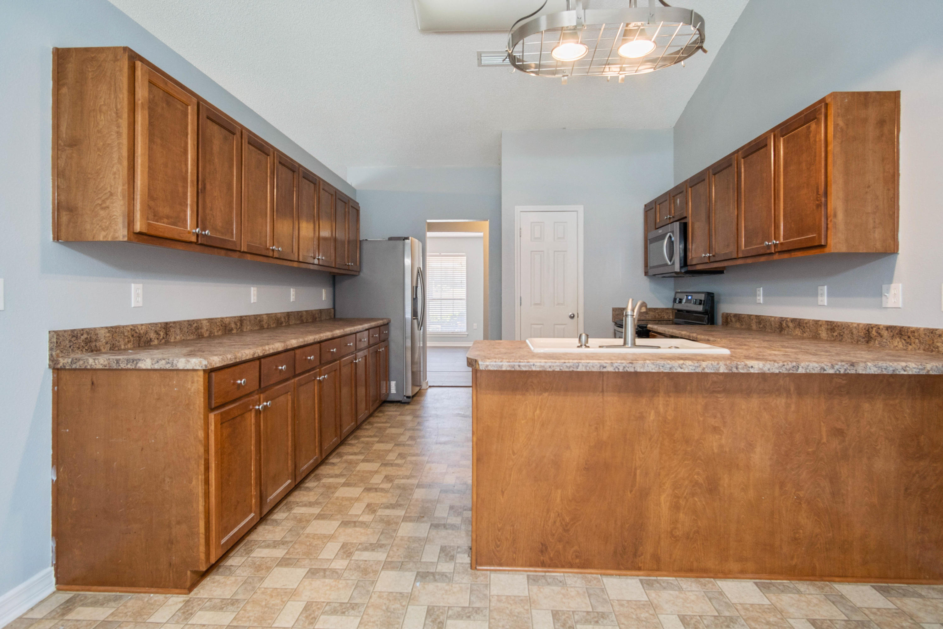 427 Triton Street Crestview, FL 32536 - Photo 12 of 32 a kitchen with stainless steel appliances granite countertop a sink a stove and a refrigerator