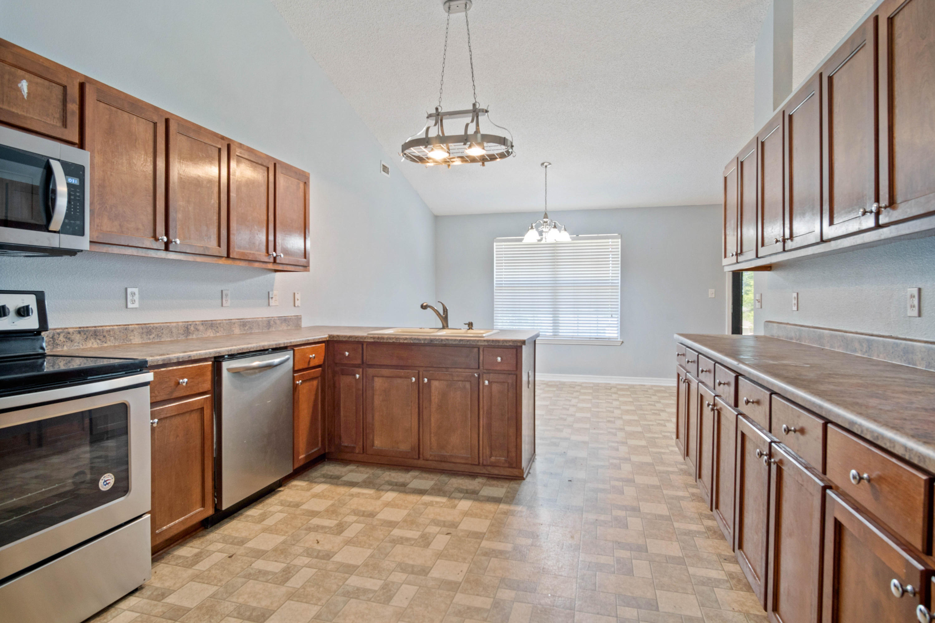 427 Triton Street Crestview, FL 32536 - Photo 13 of 32 a kitchen with stainless steel appliances granite countertop a sink stove and cabinets