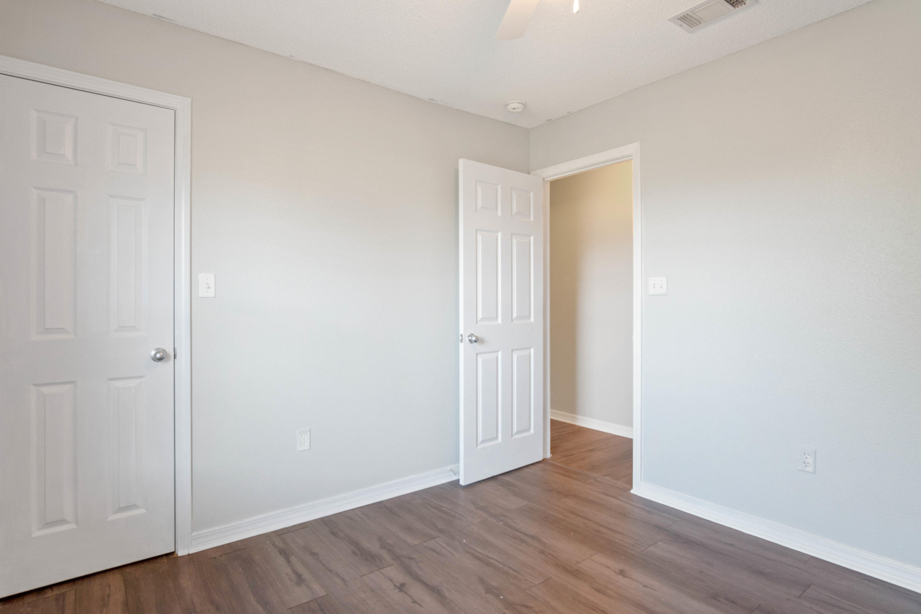 427 Triton Street Crestview, FL 32536 - Photo 21 of 32 a view of an empty room with wooden floor