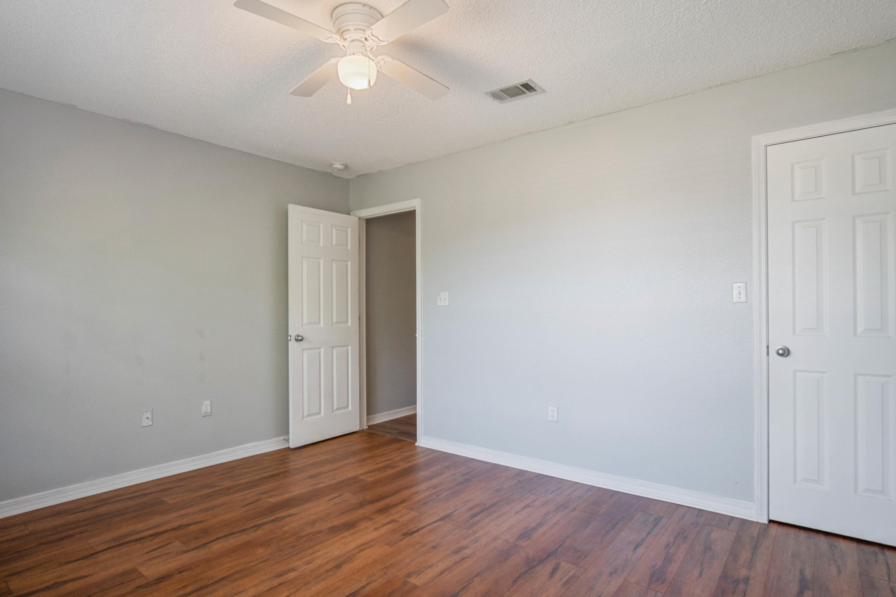 427 Triton Street Crestview, FL 32536 - Photo 24 of 32 a view of an empty room with wooden floor