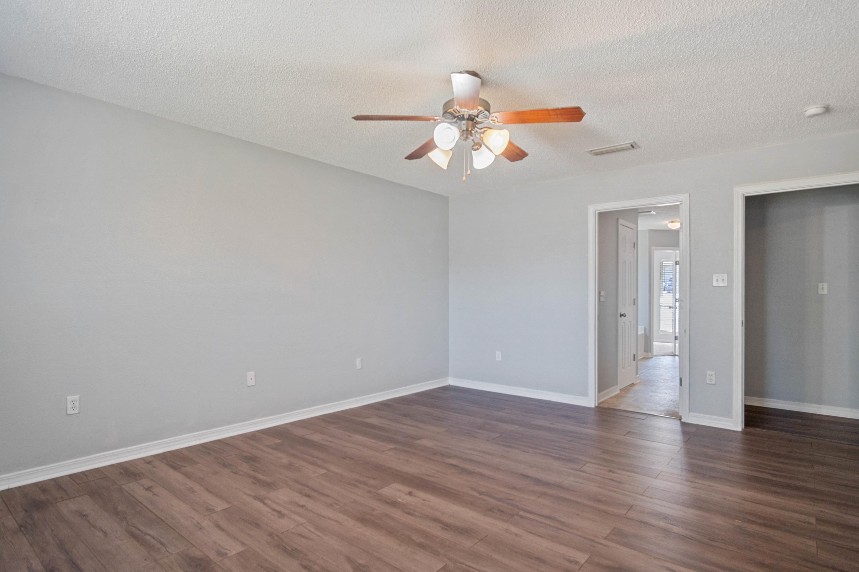 427 Triton Street Crestview, FL 32536 - Photo 26 of 32 a view of an empty room with wooden floor