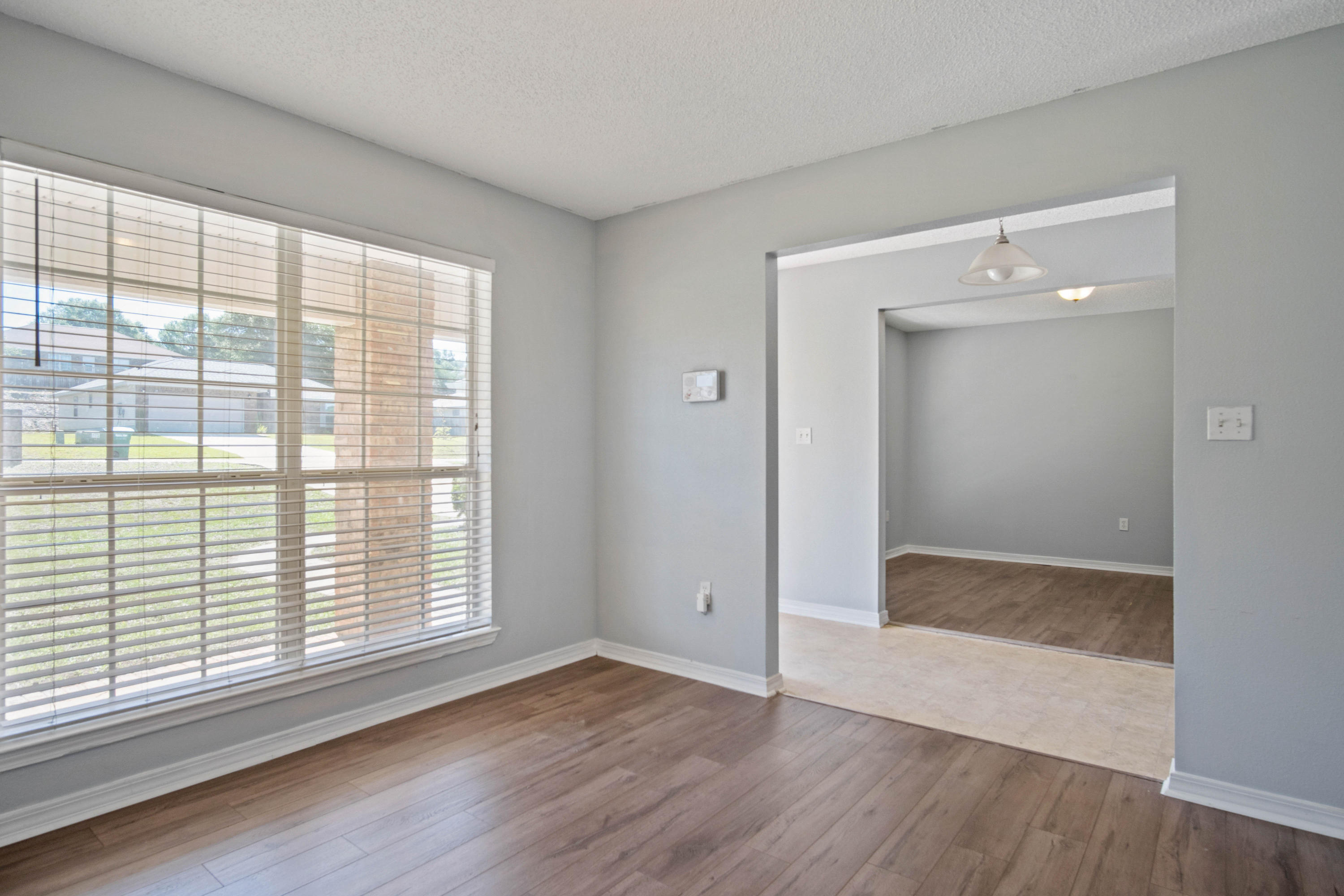 427 Triton Street Crestview, FL 32536 - Photo 4 of 32 an empty room with wooden floor and windows