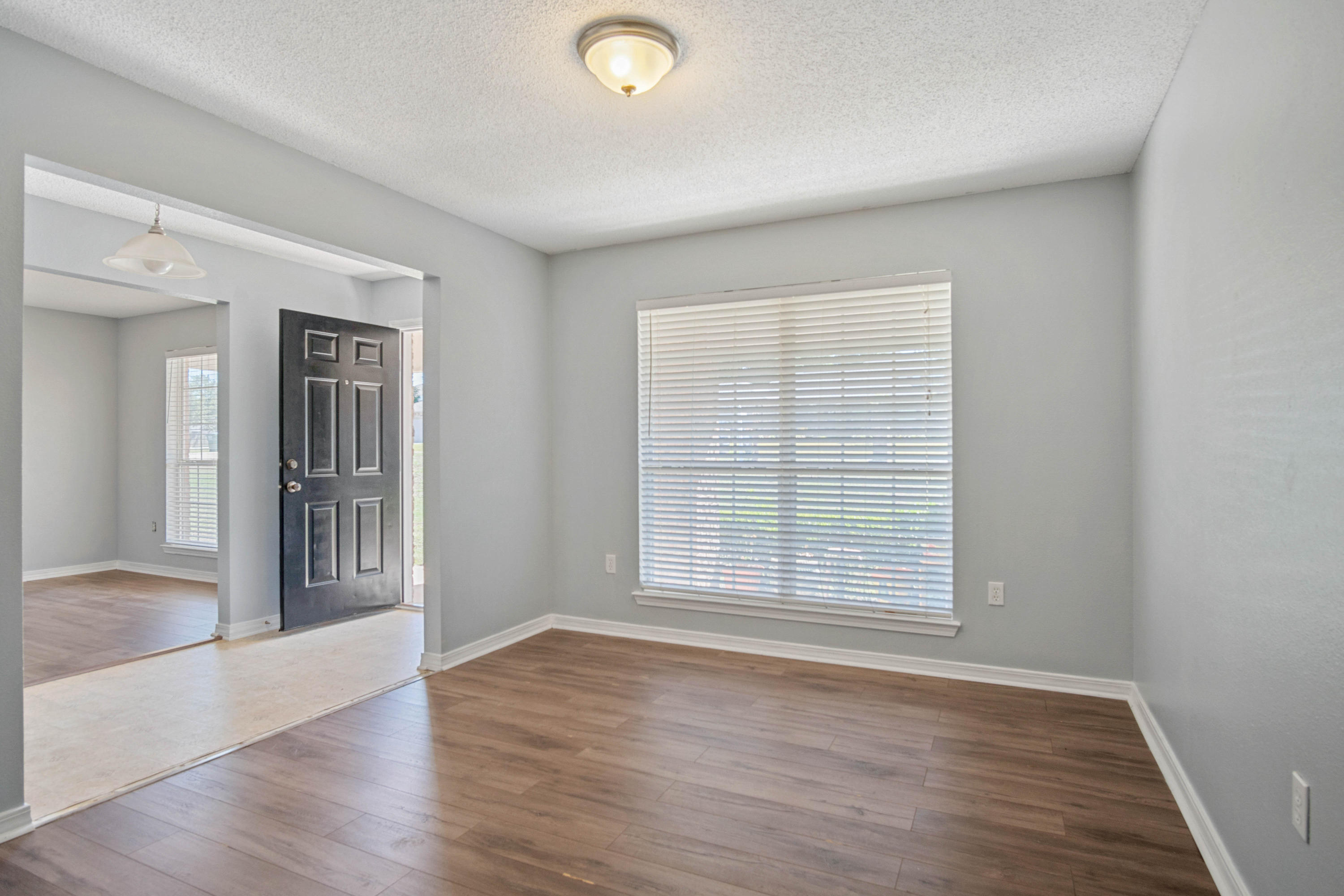 427 Triton Street Crestview, FL 32536 - Photo 5 of 32 wooden floor in an empty room with a window