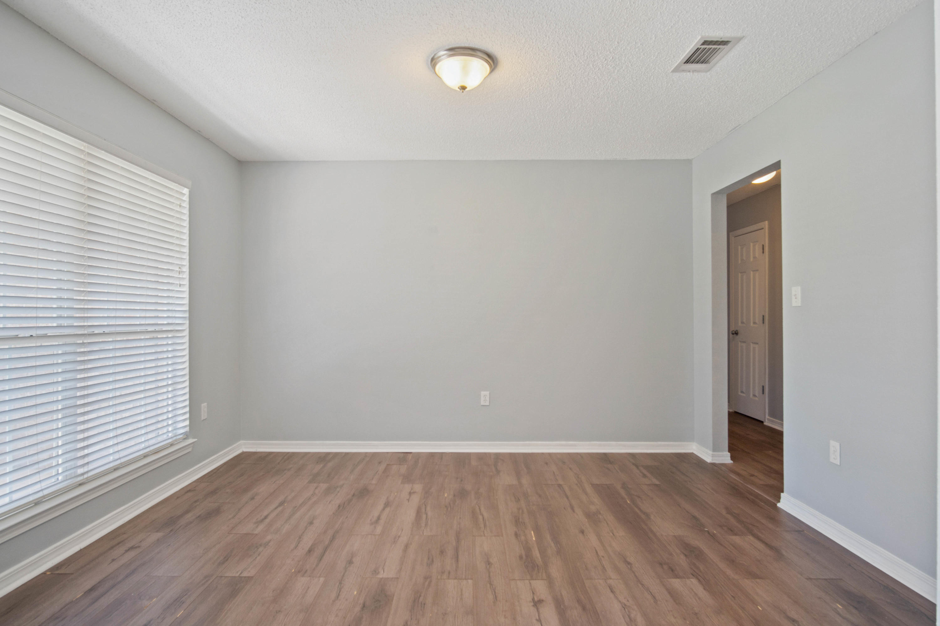 427 Triton Street Crestview, FL 32536 - Photo 6 of 32 wooden floor in an empty room