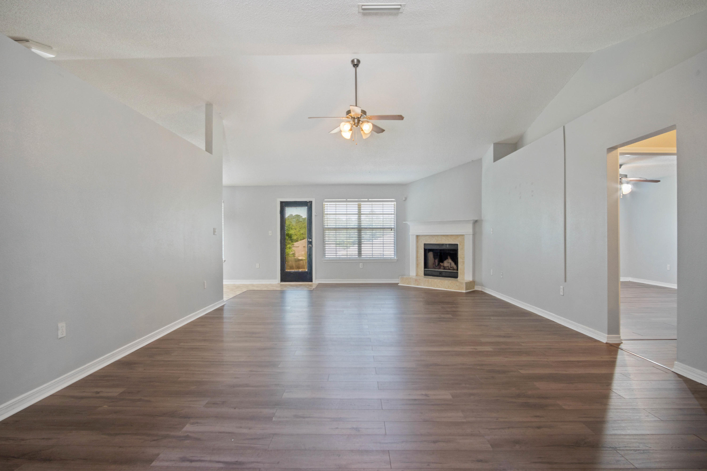 427 Triton Street Crestview, FL 32536 - Photo 8 of 32 wooden floor in an empty room with a window
