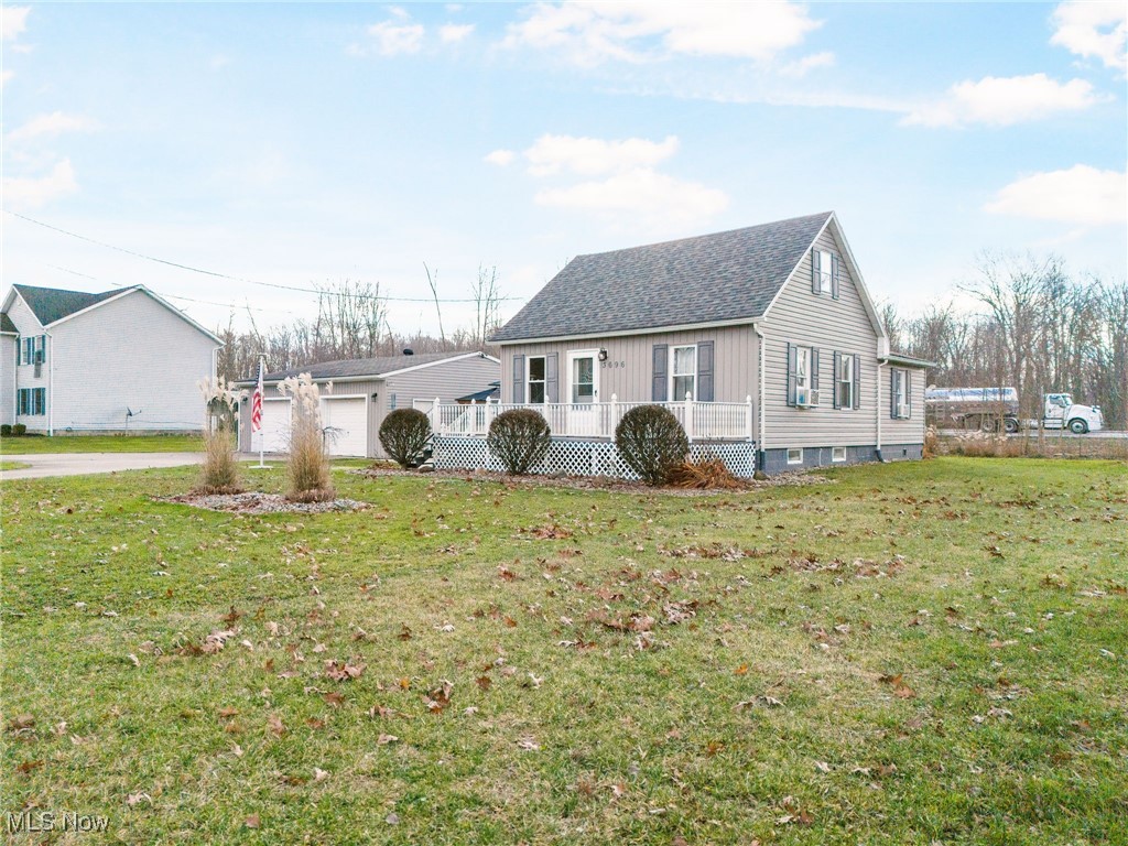 3696 Lynn Road Ravenna, OH 44266 - Photo 4 of 25 View of front facade featuring covered porch, a garage, and a front yard