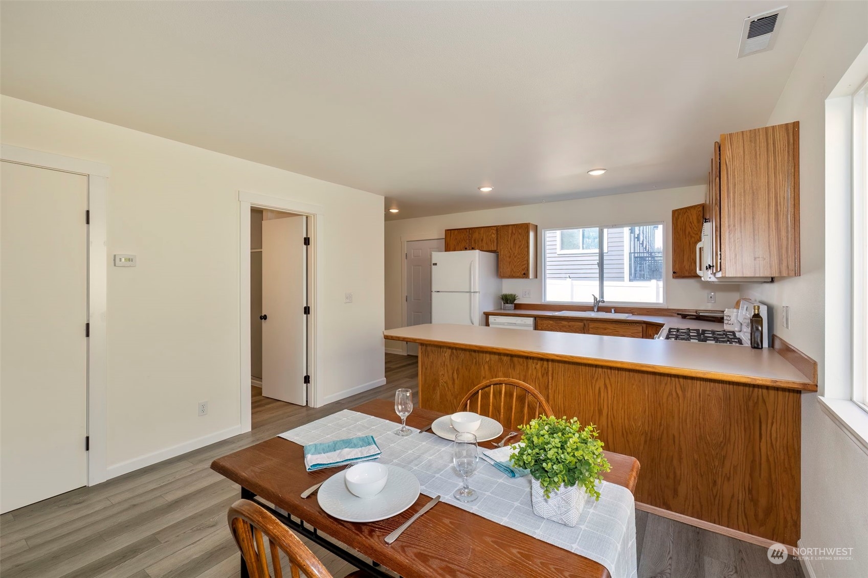 3982 Broadmoor Loop Bremerton, WA 98310 - Photo 14 of 40 a large kitchen with a table and chairs in it