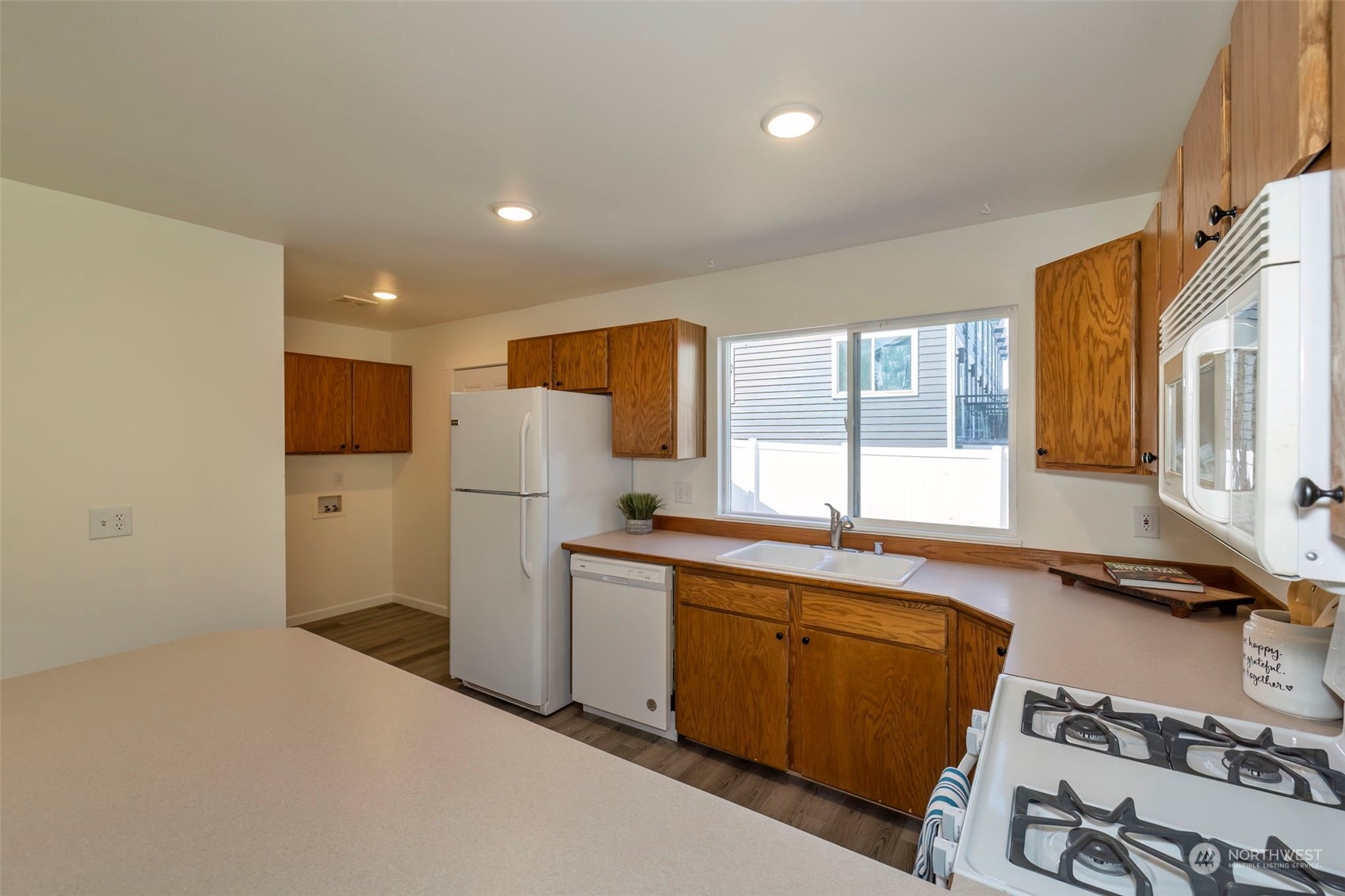 3982 Broadmoor Loop Bremerton, WA 98310 - Photo 16 of 40 a kitchen with a sink appliances and cabinets