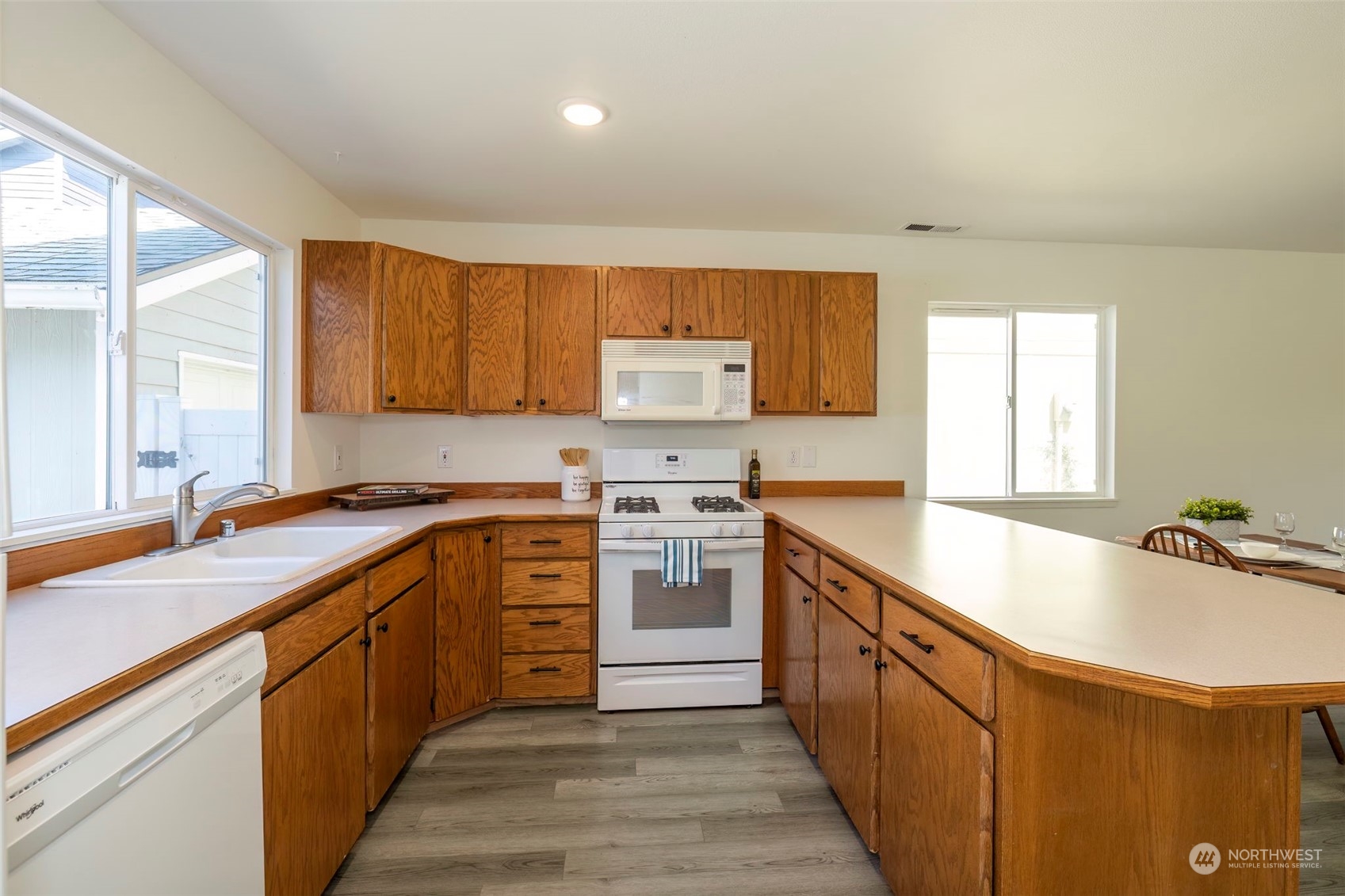 3982 Broadmoor Loop Bremerton, WA 98310 - Photo 18 of 40 a kitchen with stainless steel appliances granite countertop a sink stove and refrigerator