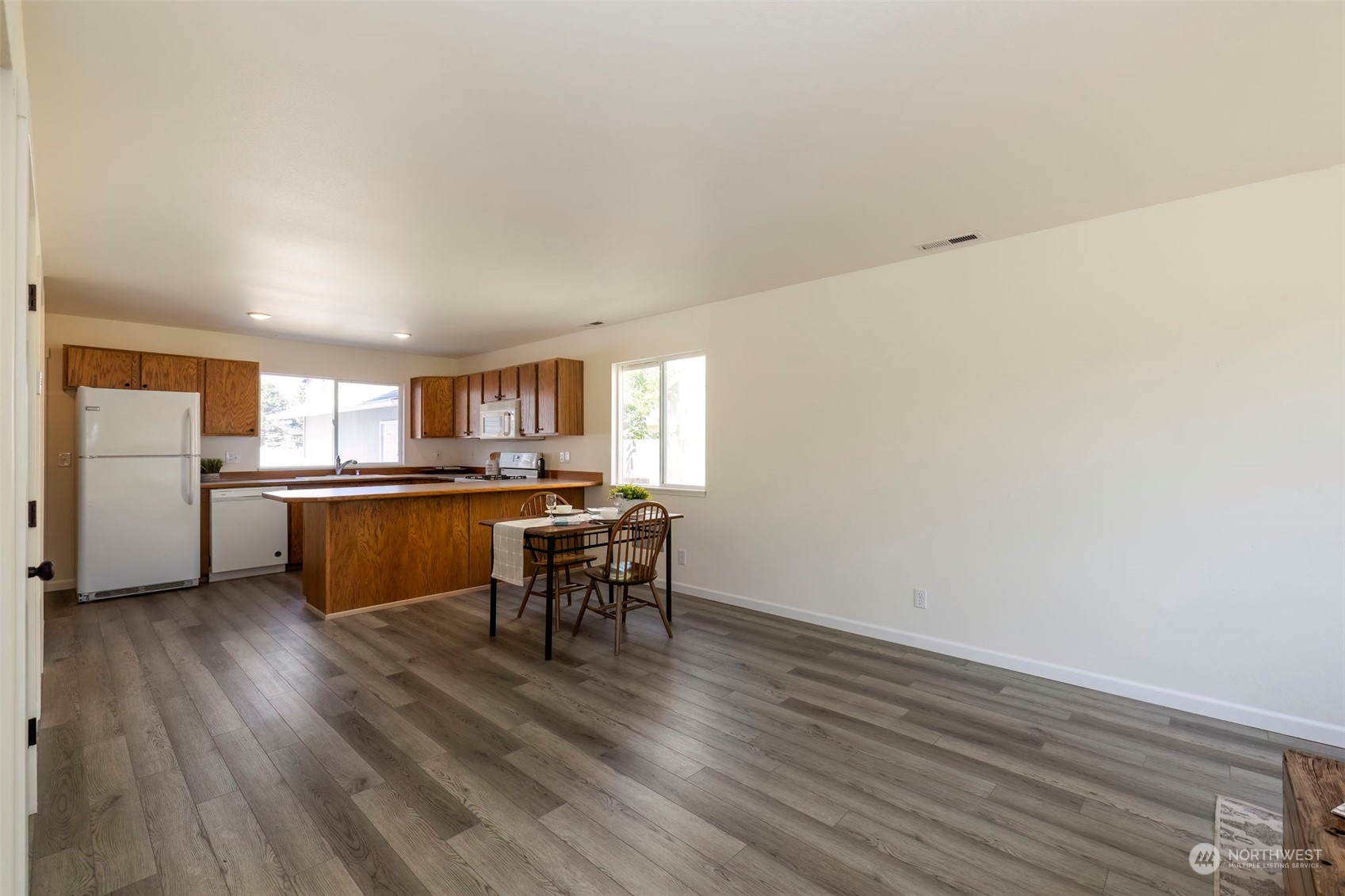 3982 Broadmoor Loop Bremerton, WA 98310 - Photo 8 of 40 a view of a kitchen with wooden floor and a kitchen