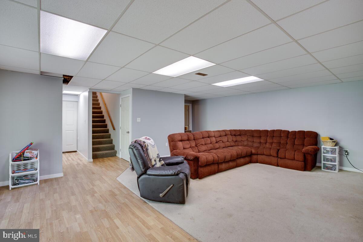 1420 Wilson Road Huntingtown, MD 20639 - Photo 33 of 43 a living room with furniture and stairs