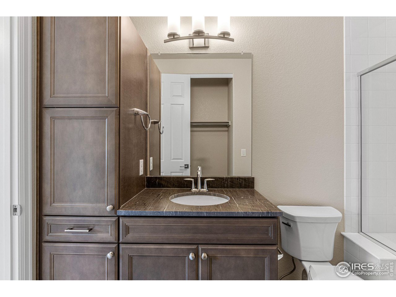1382 Eldorado Drive Superior, CO 80027 - Photo 16 of 40 a bathroom with a granite countertop sink toilet and mirror