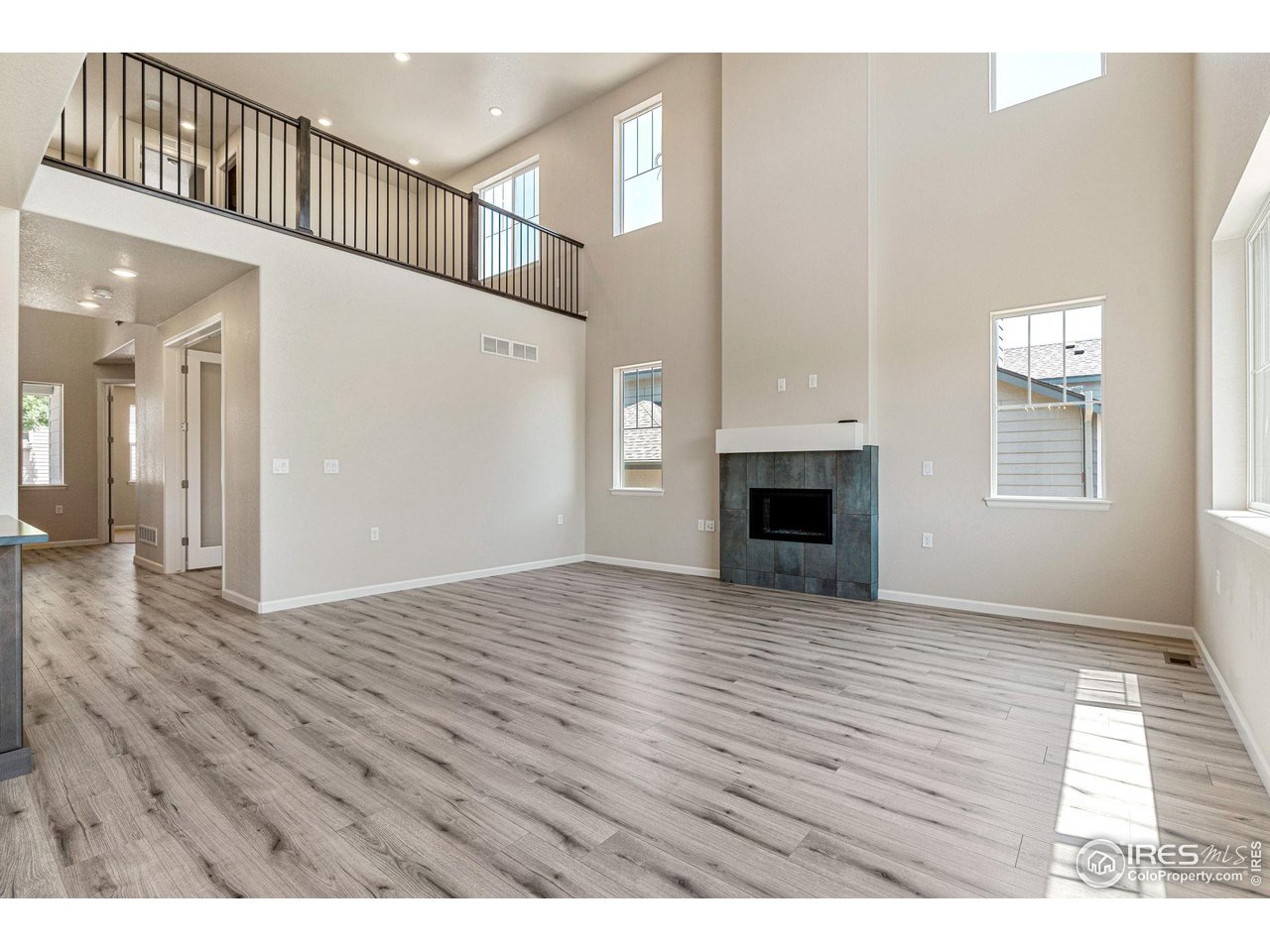 1382 Eldorado Drive Superior, CO 80027 - Photo 6 of 40 a view of an empty room with wooden floor and a fireplace