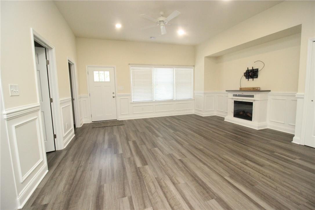 3083 Penn Allen Road, Unit B Nazareth, PA 18064 - Photo 11 of 21 Laminate flooring extends through this main living space with a white paneled fireplace and large windows.