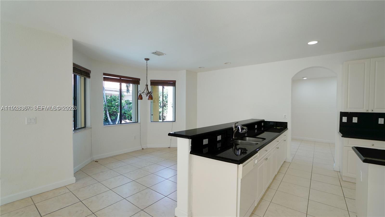 7507 Southwest 189th Street, Unit 7507 Cutler Bay, FL 33157 - Photo 11 of 28 a kitchen with a sink and cabinets