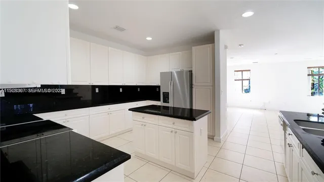 a kitchen with a sink and white cabinets